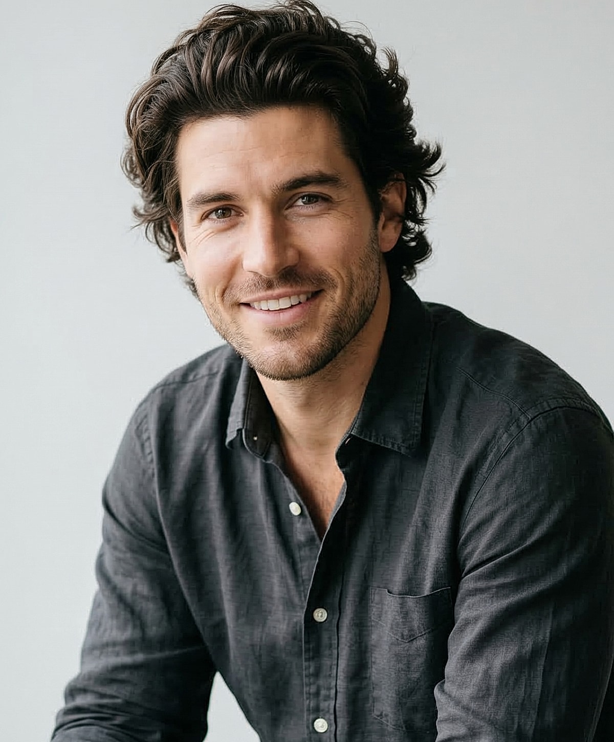 Smiling man in a casual button-up shirt.