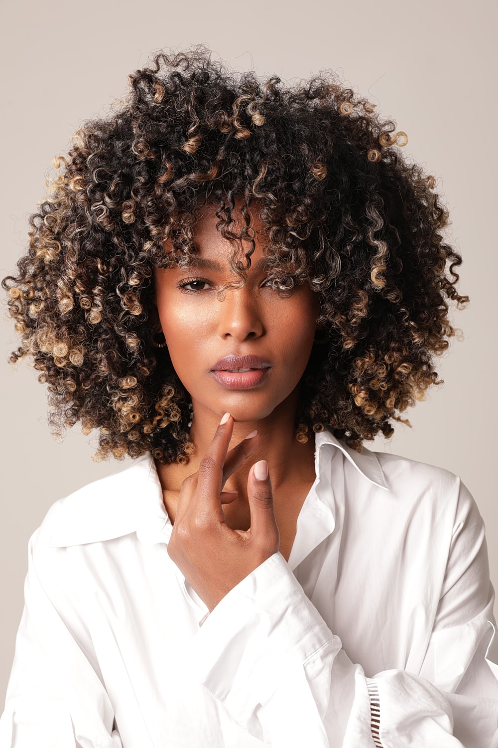 Portrait of a woman with curly hair.