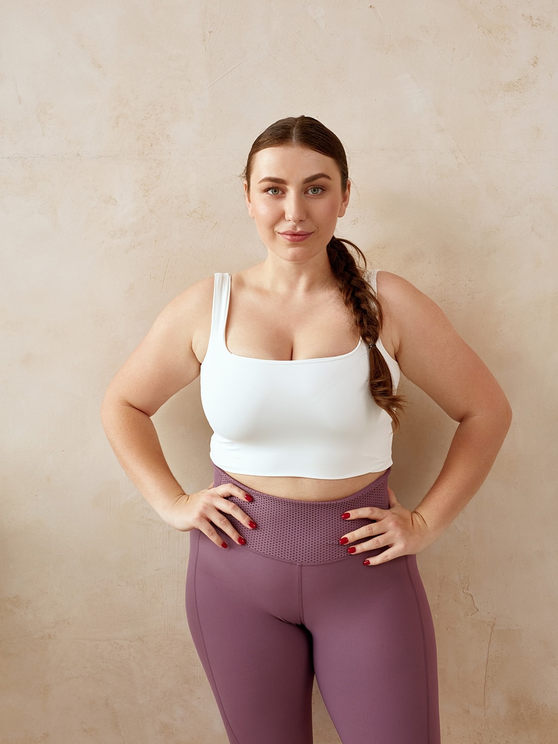 Woman in athletic wear posing confidently.