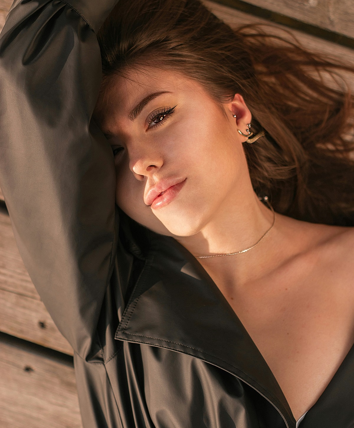 Young woman with an intense gaze, laying down.