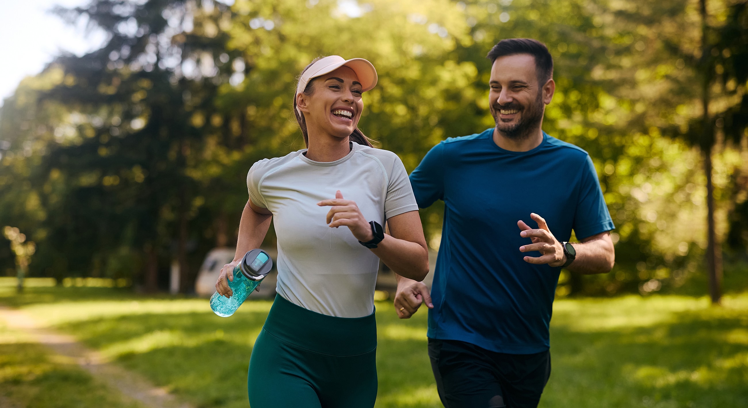 Couple enjoying a run in a park.